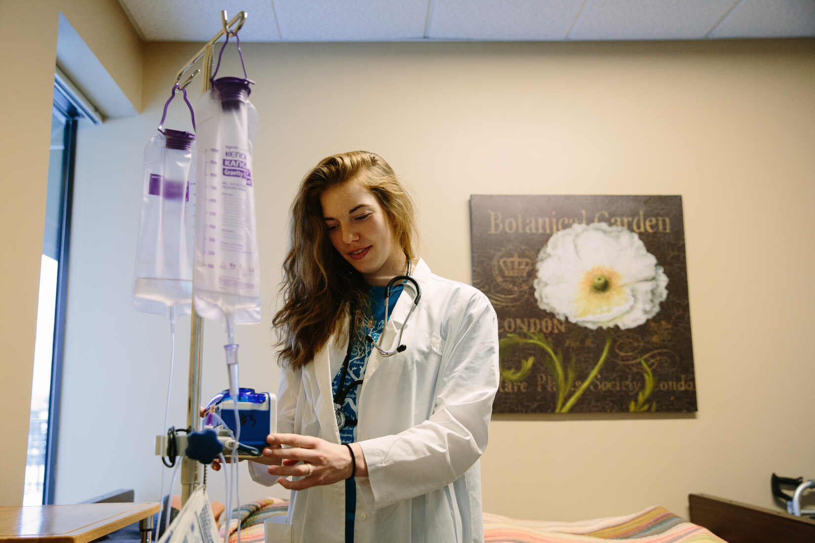 Minnesota college student who was accepted to the University of Minnesota Medical School program using a piece of medical equipment at ACR Homes following her white coat ceremony.