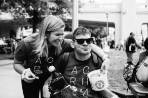 ACR Homes Direct Care Professional is providing care to a person with disabilities at the Minnesota State Fair, an activity that promotes disability inclusion and wheelchair accessibility.