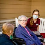 Direct Care Professionals enjoy time outside with senior citizen resident from Arthur's Senior Care at assisted living home in Shoreview, mn.