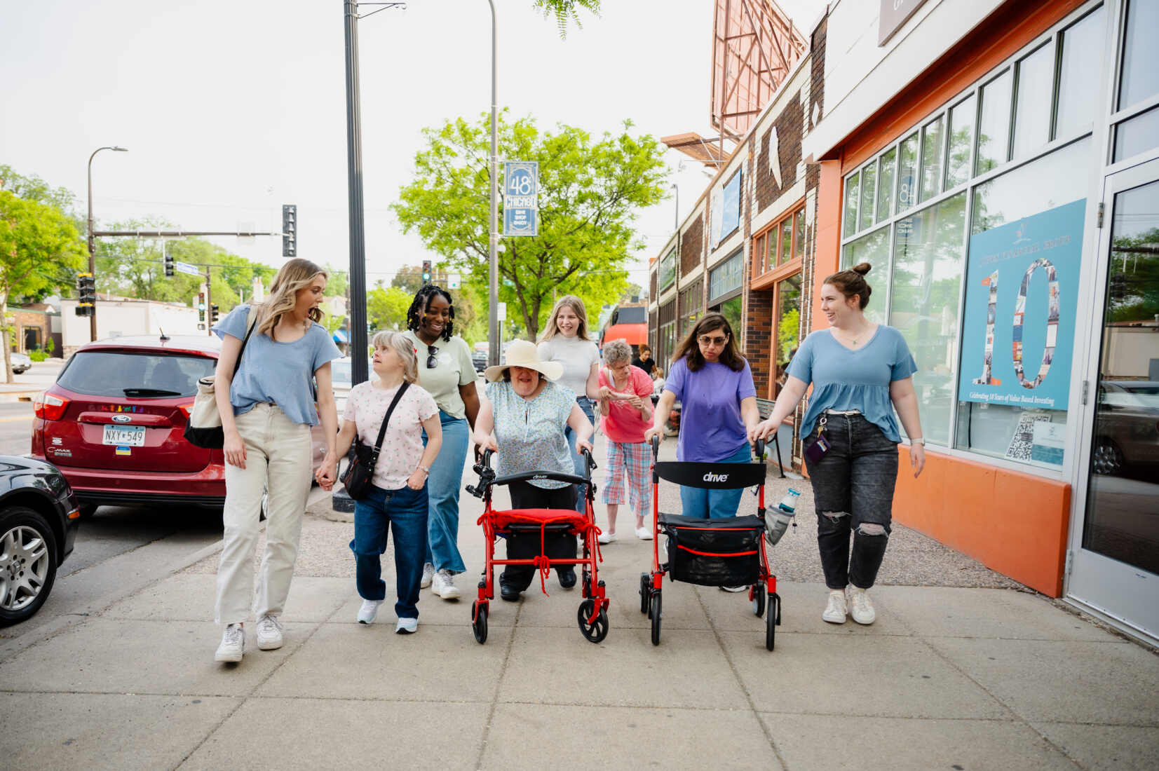 Direct Care Professional and Direct Care Assistant employees at ACR Homes take people with disabilities who are residents on a group outing for ice cream